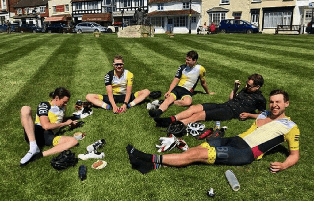 Cyclists enjoying coffee on a field