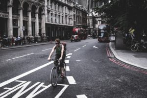 Cycling liability insurance. Cyclist riding in a city