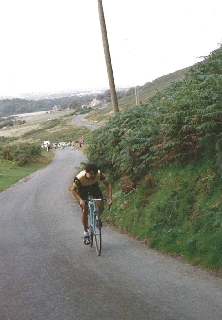 Road bike cyclist racing up hill