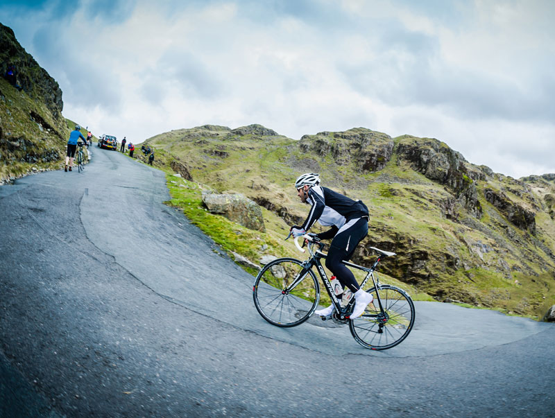road cyclist riding up a very steep hill