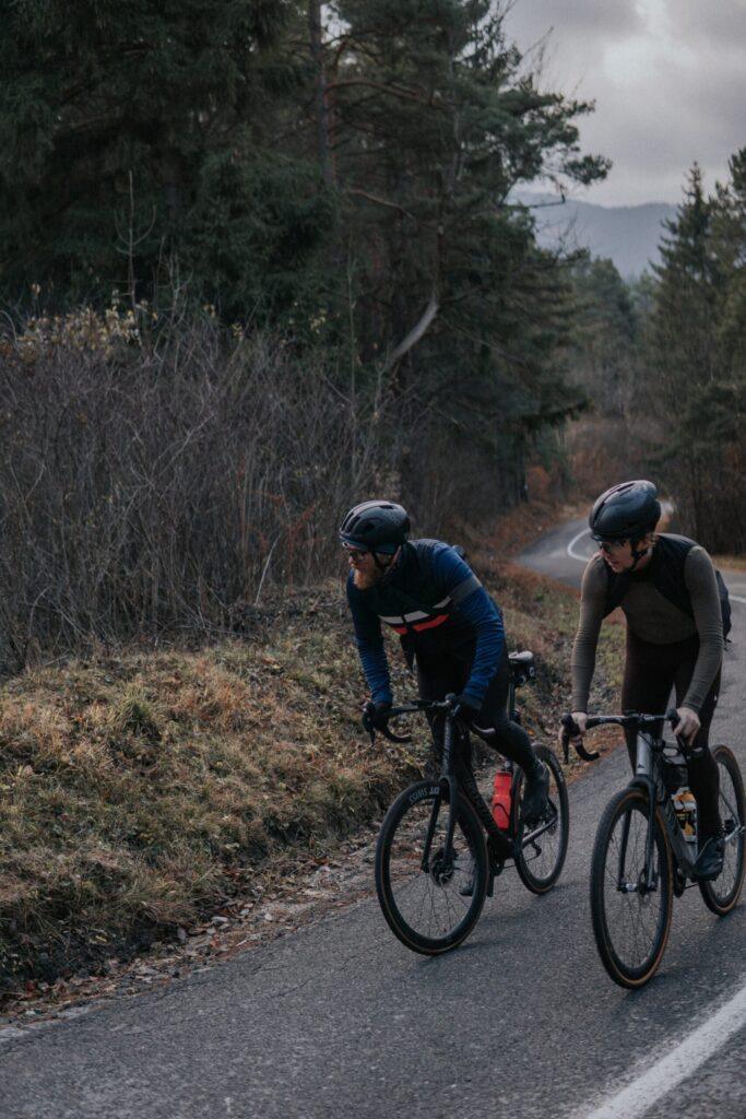two cyclists riding in cold weather