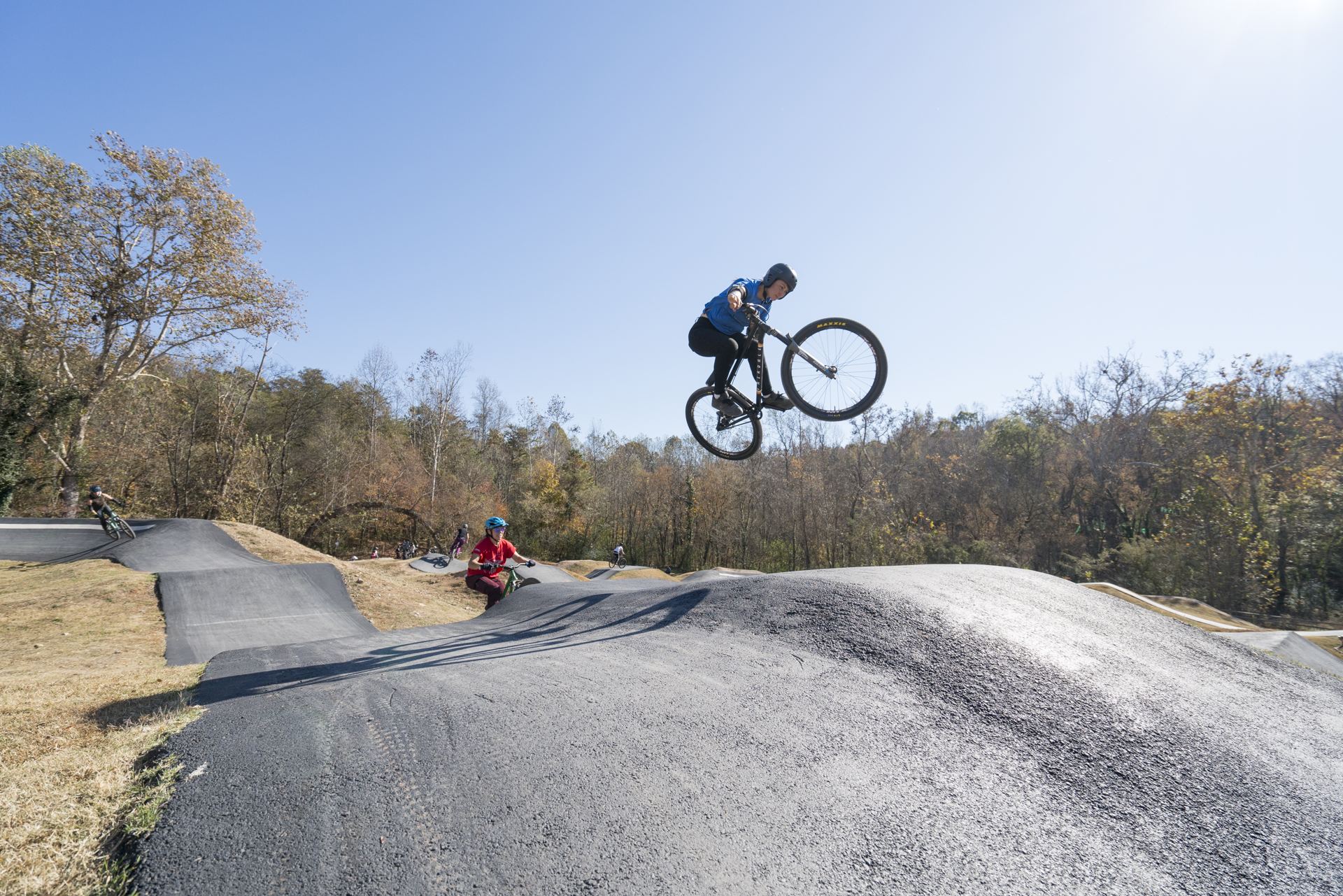 Mountain biker jumping at a pump track
