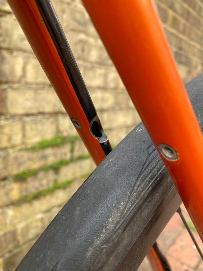 a carbon fibre bicycle frame with a hole in the seat stay