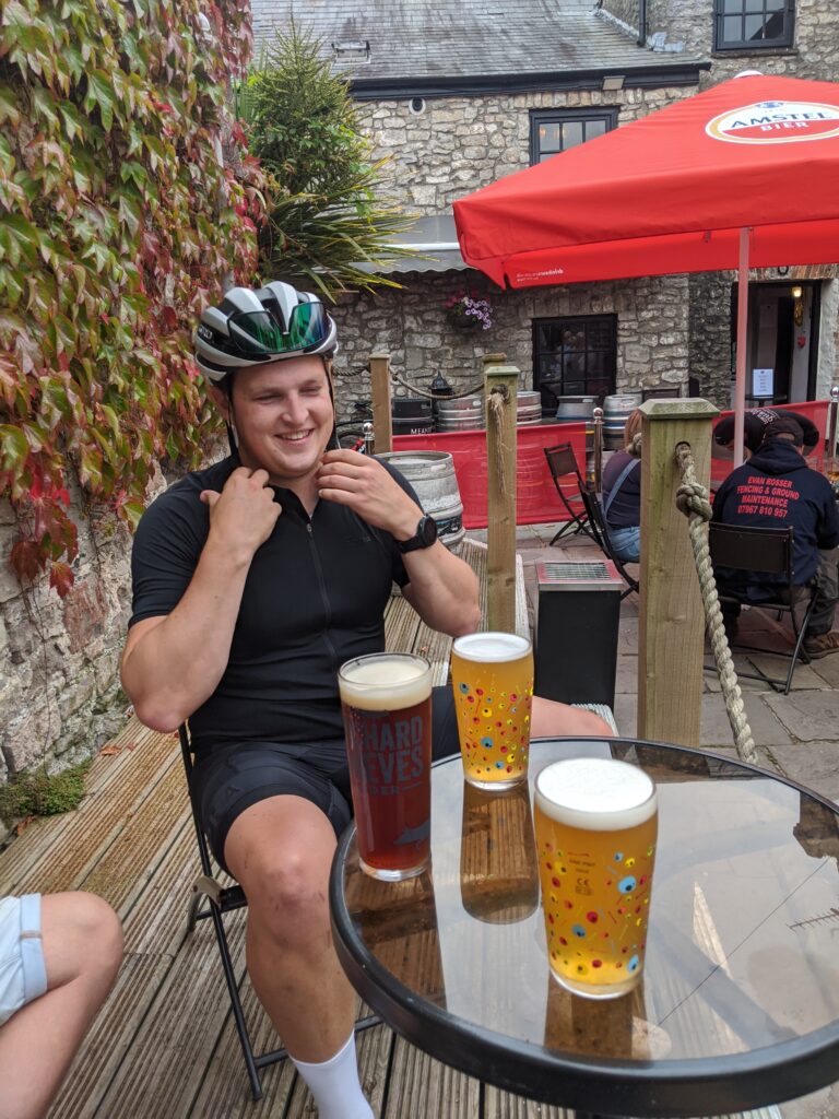 A cyclist sat down with a pint of beer